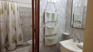 a bathroom with a sink and a mirror and towels at Depto Libertad 1 in San Francisco
