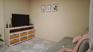 a living room with a flat screen tv on a dresser at Depto Libertad 1 in San Francisco