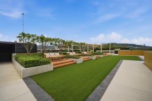 a garden on the roof of a building with grass at Seashore Beach Residences by NLA in Bang Tao Beach