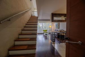 a staircase leading to a living room with a table at SINGLE RENT'APARTMENT in Concepción