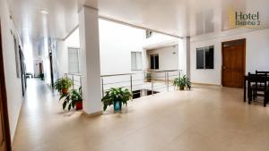 an empty hallway with potted plants in a building at Hotel Bambù 2 in Puerto Asís