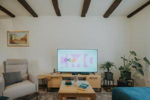 a living room with a television on a table at Kuća za odmor Back to Bašić in Mandičevac