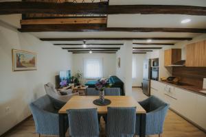 a kitchen and dining room with a table and chairs at Kuća za odmor Back to Bašić in Mandičevac