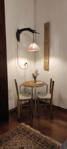 a table with two chairs and a lamp in a room at Pueblo Nómade in Tranqueras +49 photos