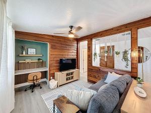 a living room with a couch and a tv at Modern 3BR Retreat with Pool & Fire Pit in Largo