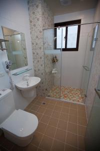 a bathroom with a shower and a toilet and a sink at Mallorca B&B in Taitung City +32 photos