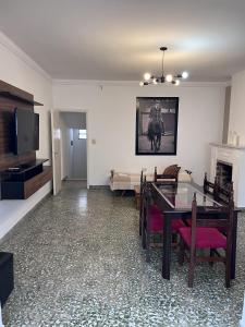 a living room with a dining table and a tv at Lomar Apart 2 - Depto céntrico Villa María in Villa María +19 photos