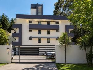 a white building with a black roof at SINGLE RENT'APARTMENT in Concepción