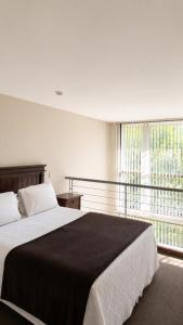 a bedroom with a large bed and a large window at SINGLE RENT'APARTMENT in Concepción +54 photos