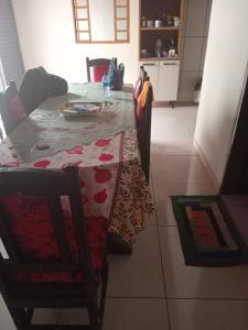 a dining room table with a table cloth on it at Leandra in Ponta Porã