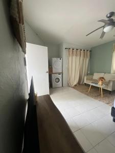 a living room with a couch and a refrigerator at Stylish villa with private pool in Koolbaai in Koolbaai +27 photos