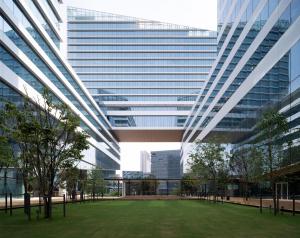 a large building with a green courtyard in front of it at YOTEL Bangkok Sukhumvit in Ban Nong Chaeng +15 photos