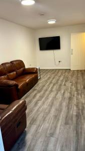 a living room with a couch and a flat screen tv at HomesRentals in Dudley
