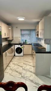 a kitchen with white cabinets and a stove top oven at HomesRentals in Dudley