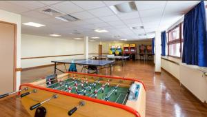 a room with a pool table and ping pong ball at Belambra terra nova in La Plagne Tarentaise