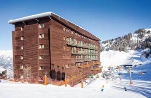 a building on a ski slope in the snow at Belambra terra nova in La Plagne Tarentaise