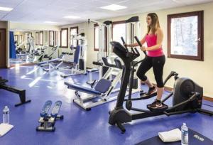 a woman standing on a treadmill in a gym at Belambra terra nova in La Plagne Tarentaise