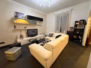 a living room with a couch and a tv at Casa Giulia in Taviano