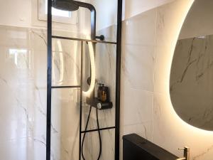 a bathroom with a shower and a mirror at Coconut Beach Villas 3 in Schinias