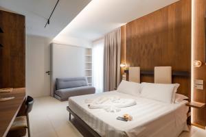 a hotel room with a bed and a chair at La Caravella in Loano