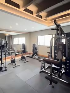 a gym with treadmills and elliptical machines at Flat 2/4 - Prestige 204 - Praia do Francês in Marechal Deodoro