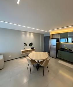 a kitchen and dining room with a table and chairs at Flat 2/4 - Prestige 204 - Praia do Francês in Marechal Deodoro