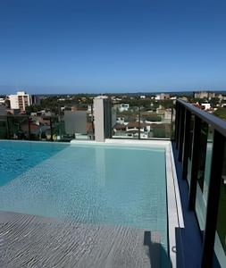 a swimming pool on the roof of a building at Flat 2/4 - Prestige 204 - Praia do Francês in Marechal Deodoro