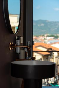 a bathroom with a sink and a window with a view at La Caravella in Loano