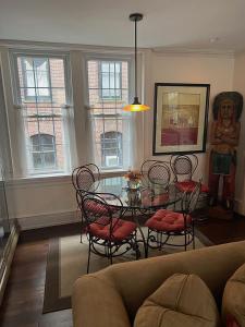 a living room with a glass table and chairs at Riverview Organic Bed & Breakfast and Wellness Center in Piermont