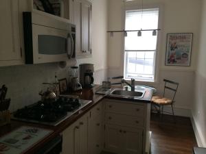 a kitchen with a sink and a stove and a microwave at Riverview Organic Bed & Breakfast and Wellness Center in Piermont +44 photos