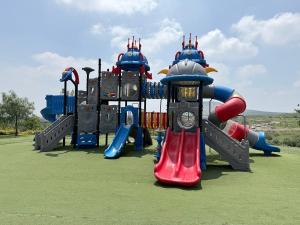 a group of playground equipment on a field at Bello departamento iluminado ideal para descansar in Querétaro