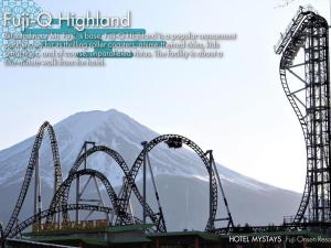 a roller coaster with a mountain in the background at KAMENOI HOTEL Fuji in Fujiyoshida