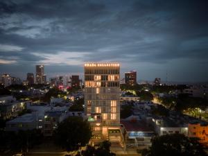 a lit up building in a city at night at Brada Collection Vendôme in Guadalajara