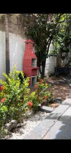 a red brick chimney sitting on the side of a house at Capitolio 02 in Canoa Quebrada