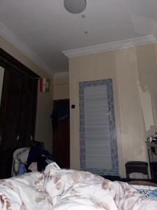 a bedroom with a bed and a window at Amran Tower in Mogadishu