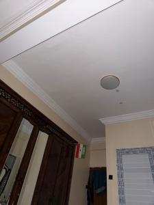 a white ceiling with a light on top of a door at Amran Tower in Mogadishu