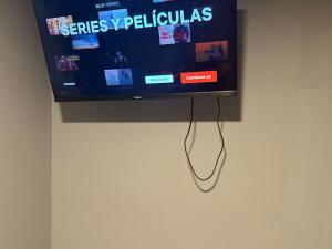 a flat screen tv hanging on a wall at Luxurious Platinum House 3VX in San Pedro Sula
