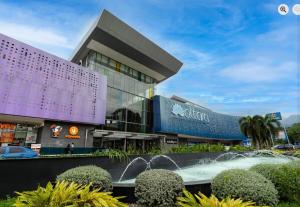 a shopping center with a fountain in front of a building at Luxurious Platinum House 3VX in San Pedro Sula