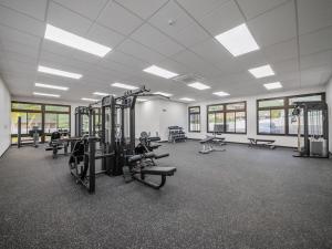 a gym with treadmills and machines in a room at Kalo Homes - Makaha Modern in Waianae