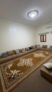 a living room with a couch and a large rug at Chez YaZ in Nouakchott