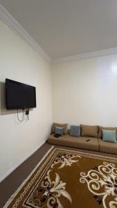 a living room with a couch and a flat screen tv at Chez YaZ in Nouakchott