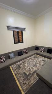 a living room with a couch and a rug at Chez YaZ in Nouakchott +2 photos