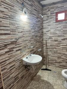 a bathroom with a sink and a toilet at Flor de Lis in Tafí del Valle +33 photos