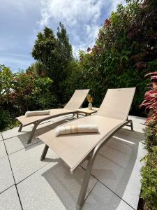 a group of chairs sitting on a patio at Gîte Ti Volkan in Saint-Claude