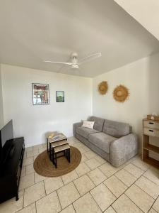 a living room with a couch and a table at Gîte Ti Volkan in Saint-Claude