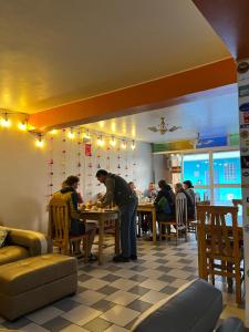 a group of people sitting at a table in a restaurant at La Casa de Maruja B&B in Huaraz