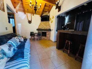 a living room with a couch and a fireplace at Cabaña el roble, Mazamitla Jalisco in Mazamitla