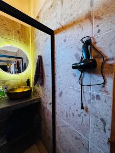 a bathroom with a phone hanging on the wall at Cabaña el roble, Mazamitla Jalisco in Mazamitla
