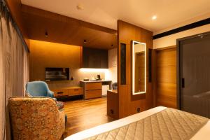 a bedroom with a bed and a chair in a room at Paramount Residency in Nedumbassery +37 photos