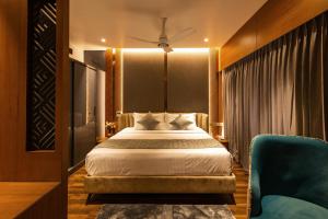 a hotel room with a bed and a couch at Paramount Residency in Nedumbassery